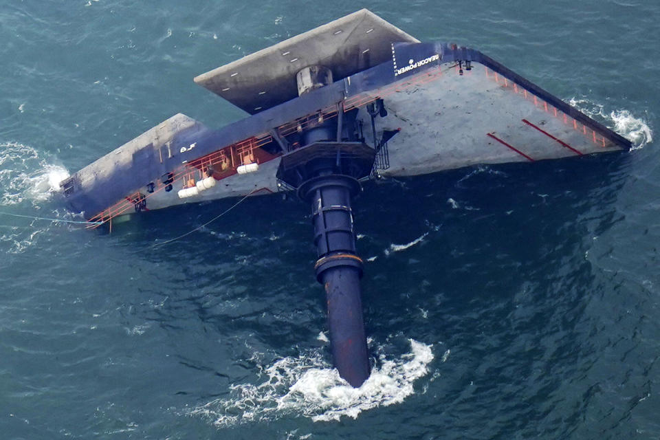 FILE - In this April 18, 2021 file photo, the capsized lift boat Seacor Power is seen seven miles off the coast of Louisiana in the Gulf of Mexico. Volunteers searching for seven men still missing after the oil industry boat capsized on April 13 said they have found life jackets and other debris from the vessel. (AP Photo/Gerald Herbert, File)