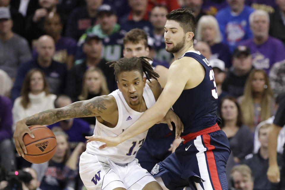 Washington's Hameir Wright (13) tries to keep the ball away from Gonzaga's Killian Tillie in the first half of an NCAA college basketball game Sunday, Dec. 8, 2019, in Seattle. (AP Photo/Elaine Thompson)