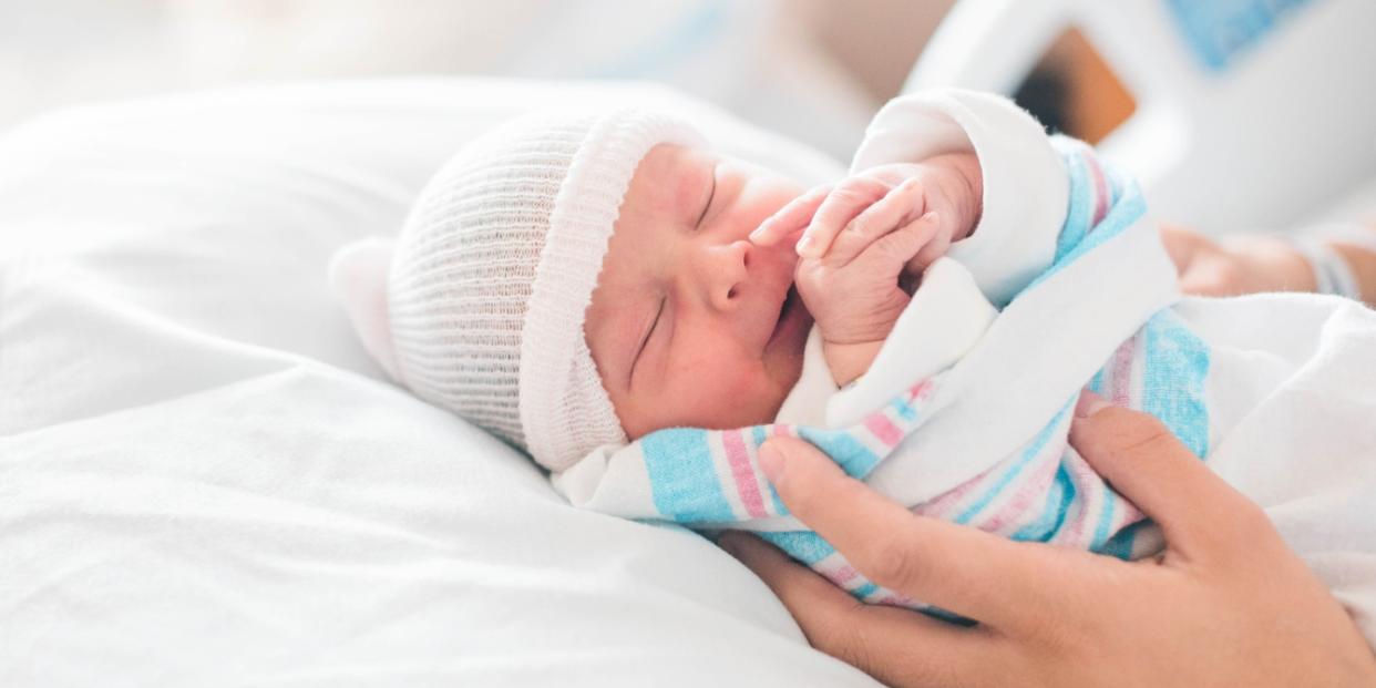 newborn baby in the hospital in mothers hands low US birth rate