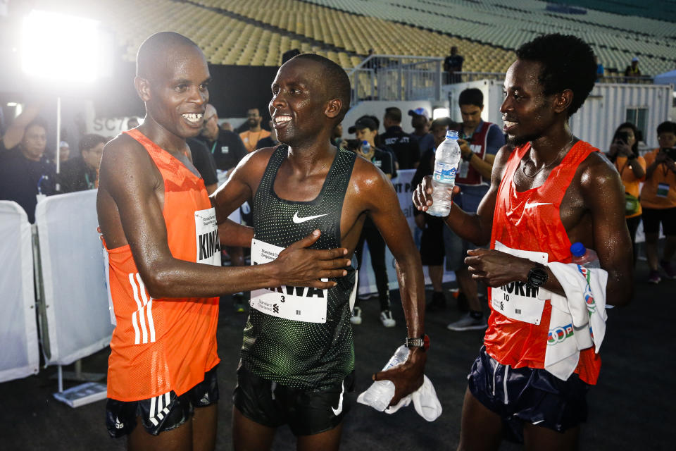 The Kenya men’s winners (from left: third-placed Andrew Kimtai, runner-up Felix Kirwa and champion Joshua Kipkorir) celebrate their feat at the Standard Chartered Singapore Marathon. (PHOTO: Standard Chartered Singapore Marathon)