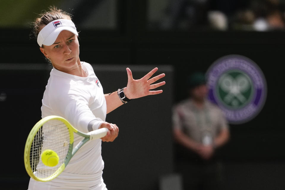 Barbora Krejcikova of the Czech Republic plays a forehand return to Jasmine Paolini of Italy during the women's singles final at the Wimbledon tennis championships in London, Saturday, July 13, 2024. (AP Photo/Alberto Pezzali)