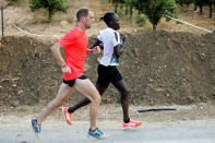 Lonah Chemtai, a Kenyan-born runner who will represent Israel in the women's marathon at the 2016 Rio Olympics, trains with her husband and coach, Israeli Dan Salpeter, near their house in Moshav Yanuv, central Israel July 14, 2016. REUTERS/Baz Ratner