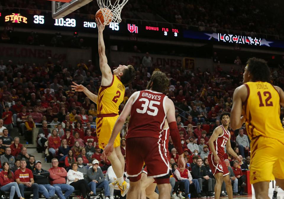 Iowa State University Cyclones guard Caleb Grill (2) tries to lay up the ball around Oklahoma Sooners'forward/center Tanner Groves (35) during the second half at Hilton Coliseum on Saturday, Feb. 25, 2023, in Ames, Iowa.