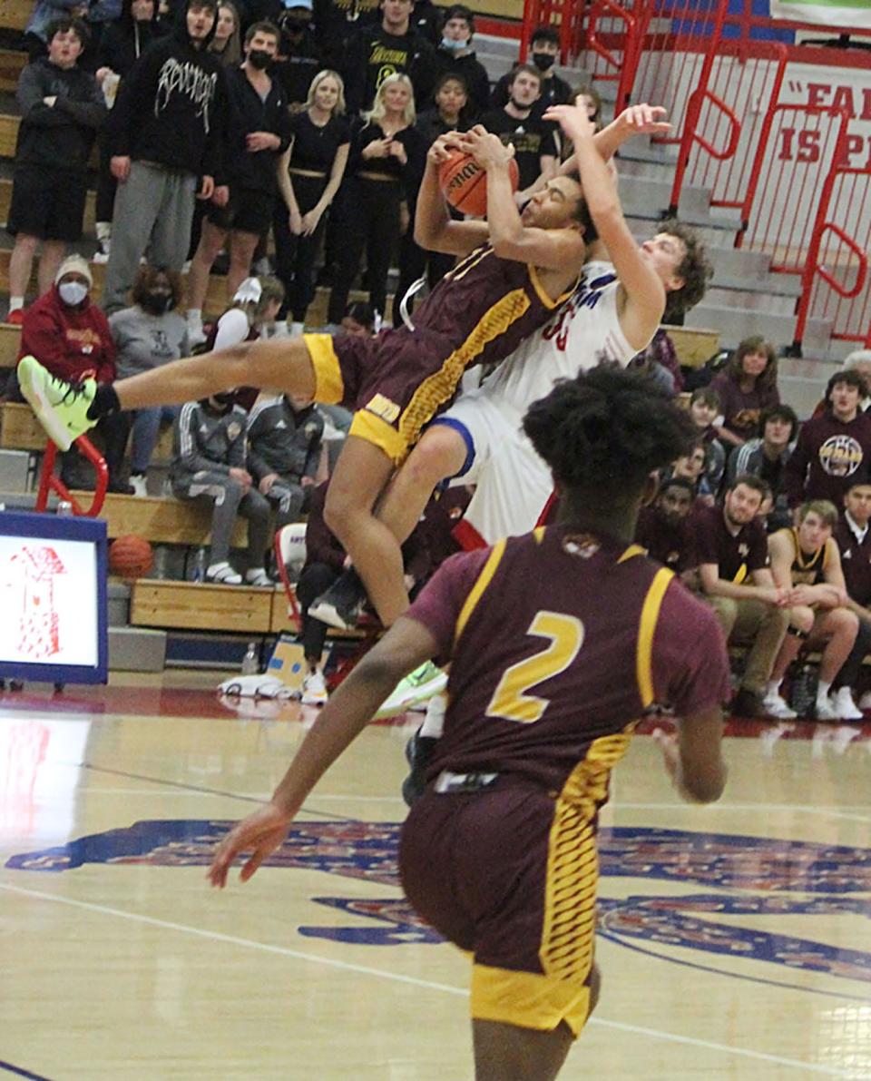 Bloomington North junior Bril Kante goes high up for an out-of-bounds pass and draws a foul during Friday's game at Martinsville. 