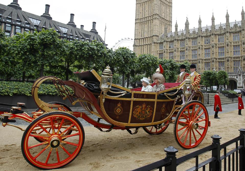 Britain.s Queen Elizabeth II travels by carriage to Buckingham Palace with Camilla, the Duchess of Cornwall after a lunch at Westminster Hall in London Tuesday June 5, 2012. Crowds cheering "God save the queen!" and pealing church bells greeted Queen Elizabeth II on Tuesday as she arrived for a service at St. Paul's Cathedral on the last of four days of celebrations of her 60 years on the throne. (AP Photo/Peter Byrne, Pool)