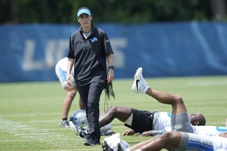 Detroit Lions Director of Sports Medicine Jill Costanza observes as team members stretch before an NFL football practice, Tuesday, June 4, 2024, in Allen Park, Mich. Costanza’s interest in studying ACL injuries and passion for learning new ways to improve performance led the former high school basketball coach and PE teacher on a journey from college sports to the Army to the Air Force to the NFL. Now, she’s an asset for a team with Super Bowl aspirations. (AP Photo/Carlos Osorio)