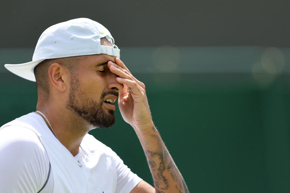 Australia's Nick Kyrgios reacts as he competes against Britain's Paul Jubb during their men's singles tennis match on the second day of the 2022 Wimbledon Championships at The All England Tennis Club in Wimbledon, southwest London, on June 28, 2022. - RESTRICTED TO EDITORIAL USE (Photo by Adrian DENNIS / AFP) / RESTRICTED TO EDITORIAL USE (Photo by ADRIAN DENNIS/AFP via Getty Images)