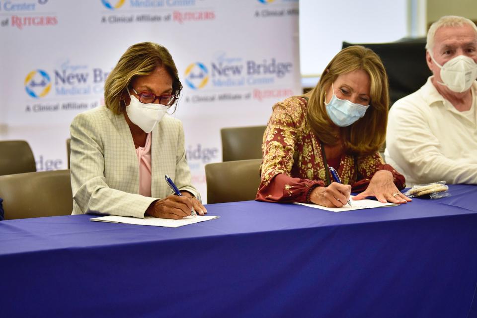 Deb Visconi, Bergen New Bridge Medical Center President and Debbie White, HPAE State Officer President, sign a new 3-year contract as Jeff Peck, HPAE Local #5091 President and Bergen New Bridge RN, looks on during the ceremonial signing event securing the seamless continuation of one of the largest healthcare workforces in northern New Jersey at Bergen New Bridge in Paramus, Wednesday on 07/27/22.