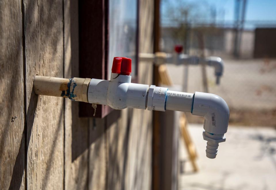 Water spigots are seen on the side of a pump house at the St. Anthony Mobile Home Park in Mecca, Calif., Thursday, March 24, 2022.