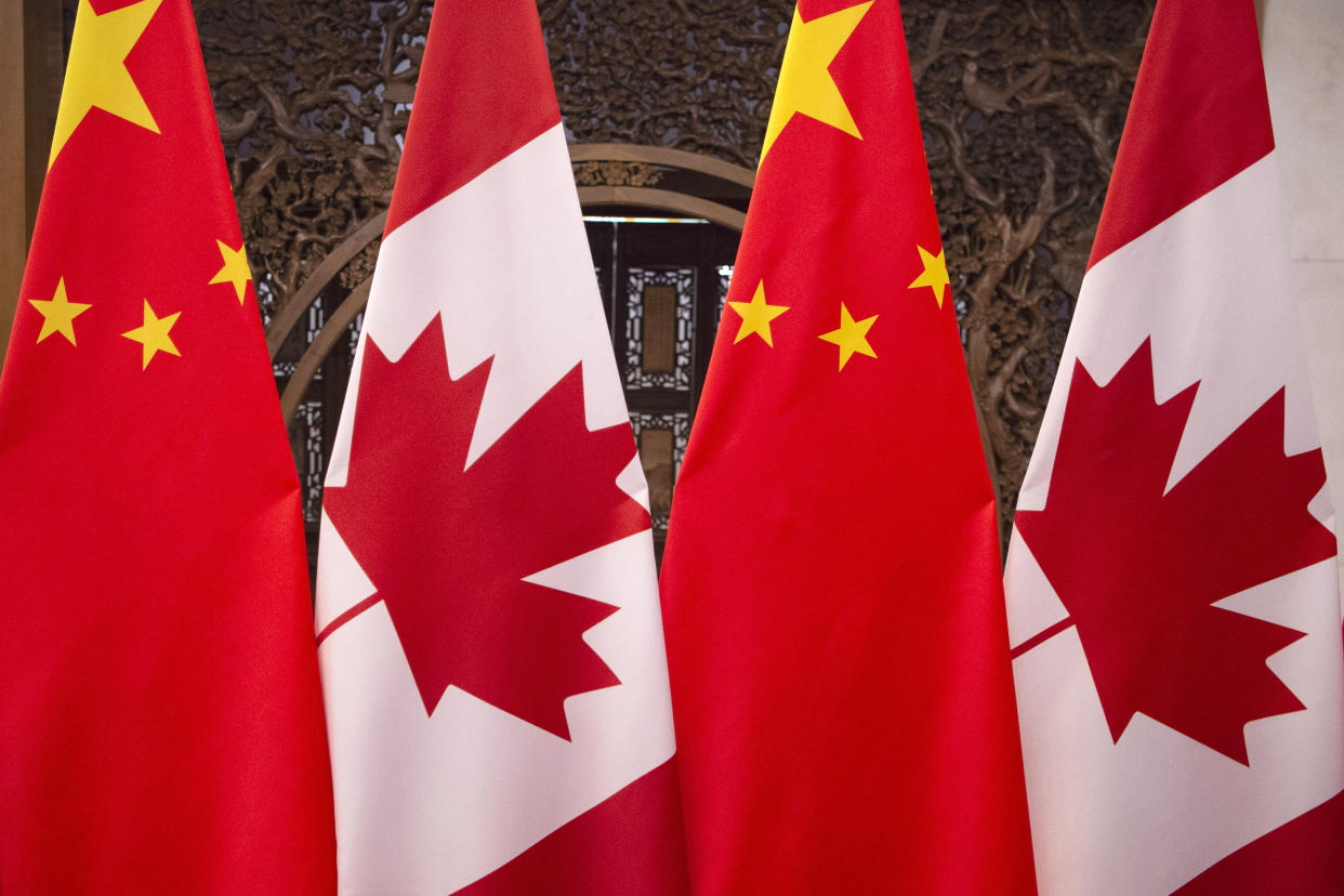 This Dec. 5, 2017, photo shows flags of Canada and China prior to a meeting of Canadian Prime Minister Justin Trudeau and Chinese President Xi Jinping at the Diaoyutai State Guesthouse in Beijing. (Fred Dufour/Pool Photo via AP)