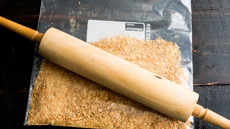 Rolling pin and bag of crumbs on counter