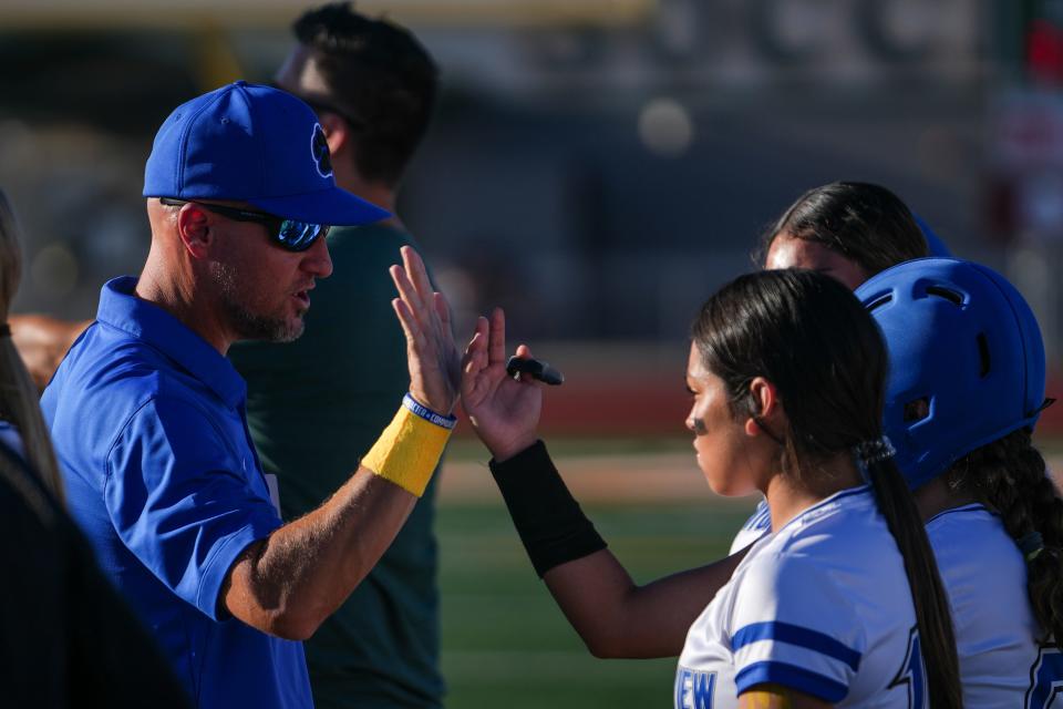 Canyon View High School flag football head coach Cory Beal (left) high fives player Audrina Cabrera (14), right, during a flag football game against Campo Verde High School at Campo Verde High School in Gilbert on Sept. 5, 2023.