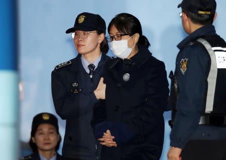 Choi Soon-sil, a confidante of former South Korean president Park Geun-hye, heads to take a bus to a detention center after being sentenced to 20 years in jail in Seoul, South Korea February 13, 2018. Yonhap via REUTERS