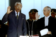ANC leader Nelson Mandela takes the oath of office before Chief Justice Michael Corbett at the Union Building May 10, 1994. Mandela became the first black president of South Africa. (Peter Andrews / Reuters)