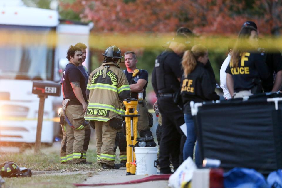 Police and firefighters investigate the scene of a house fire where eight members of the same family died in Broken Arrow, Oklahoma (Tulsa World)