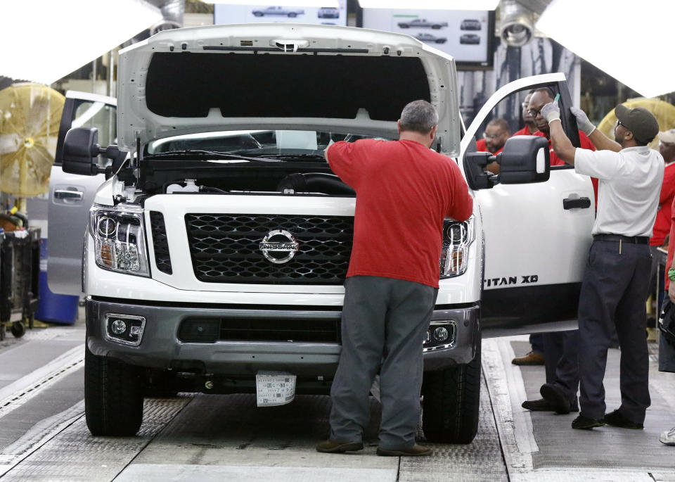 FILE- In this March 19, 2018, file photo technicians make final inspections to vehicles on the assembly line at the Nissan Canton Assembly Plant, in Canton, Miss. Nissan Motor Co. announced Thursday, Jan. 17, 2019, that it’s cutting up to 700 contract workers at its Mississippi assembly plant, citing slowing sales for vans and Titan pickup trucks that it makes there. (AP Photo/Rogelio V. Solis, File)