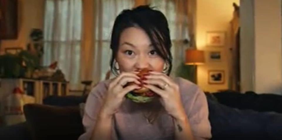 The advert, which features a woman eating a Tesco burger, was said to be misleading (Tesco/PA)
