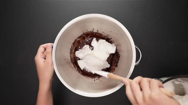 Folding meringue into cake batter with spatula