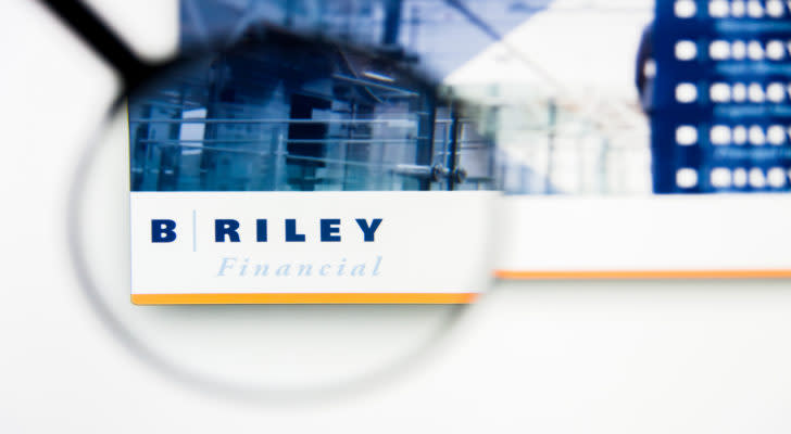 a magnifying glass enlarges the B. Riley logo on a website