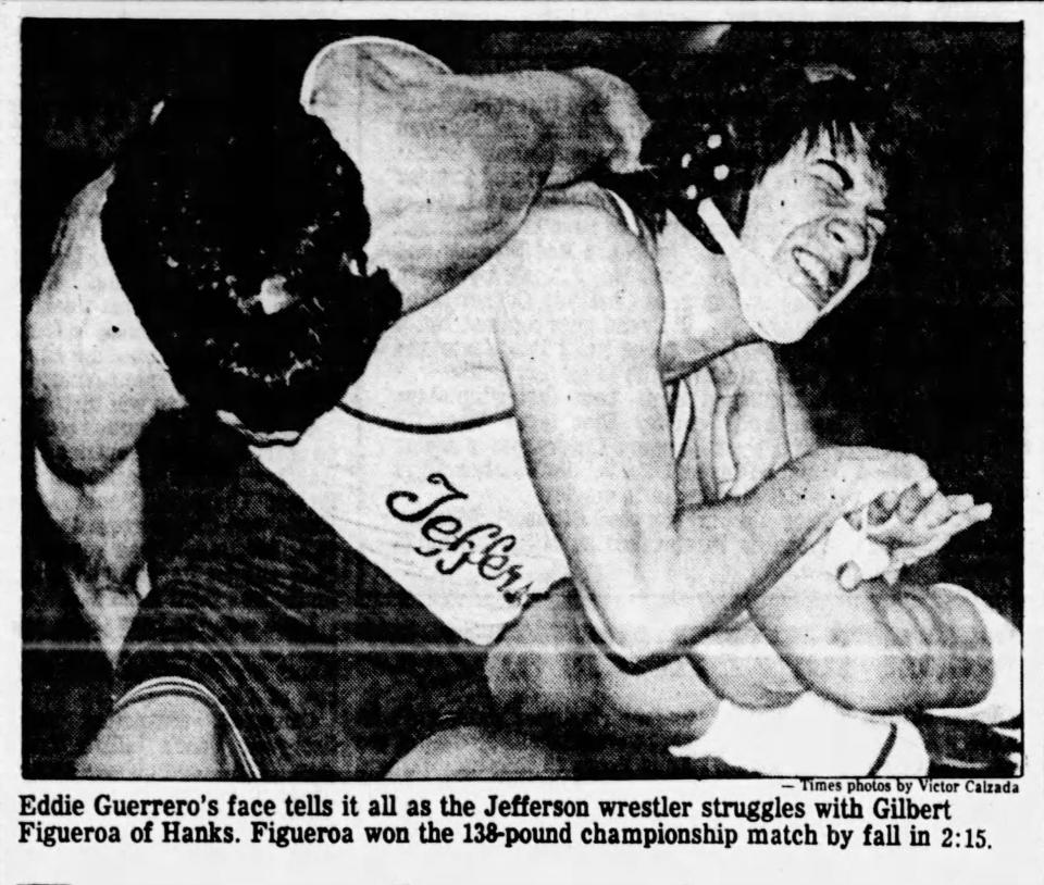 02/10/1985 Eddie Guerrero's face tells it all as the Jefferson wrestler struggles with Gilbert Figueroa of Hans. Figueroa won the 138-pound championship match by fall in 2:15.