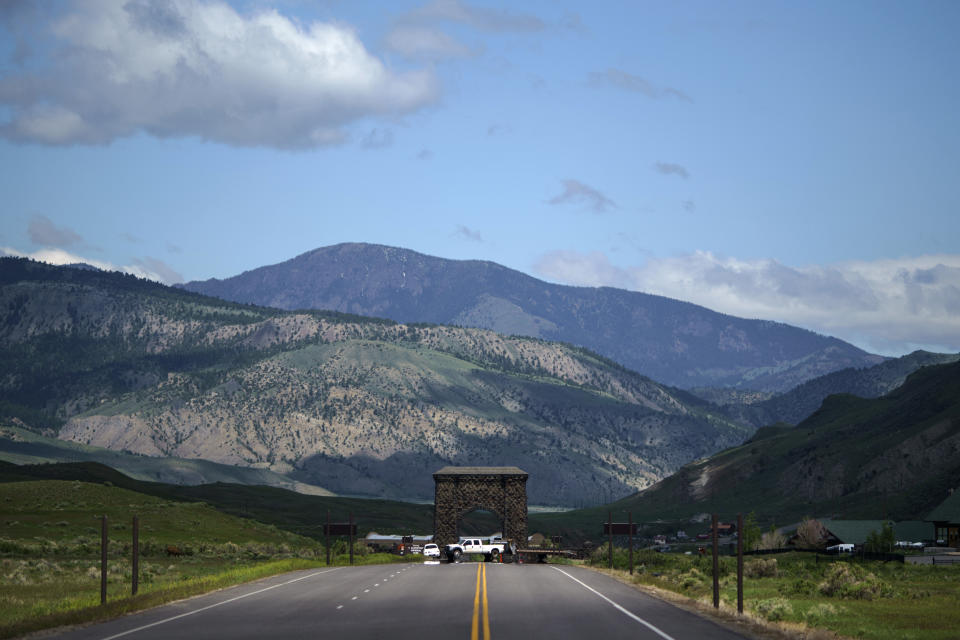 Vehicles block the entrance to Yellowstone National Park, a major tourist attraction now closed due to the historic floodwaters, Wednesday, June 15, 2022, in Gardiner, Mont. (AP Photo/David Goldman)