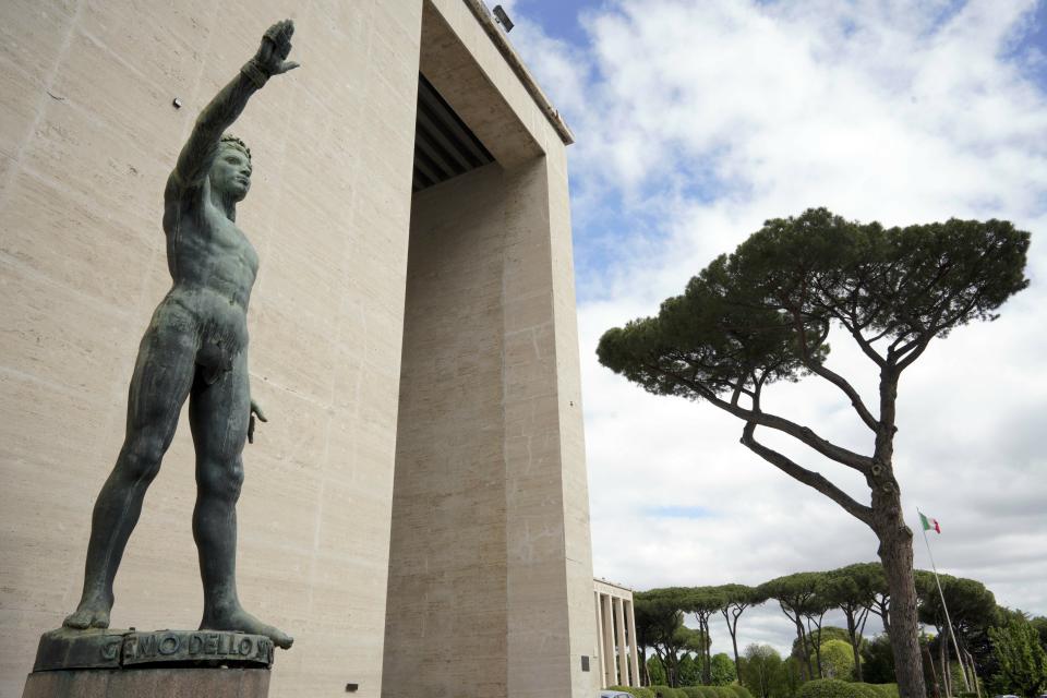 A bronze sculpture by Italo Griselli, known under the Fascist regime as "Saluto Fascista" (Fascist Salute) and after the war renamed Genio dello Sport (Genius of Sport), stands at the entrance of a fascist architecture building in the EUR neighborhood, in Rome, Monday, May 6, 2019. Mussolini transformed Rome’s urban landscape with grand construction projects like EUR, a new city district that was originally designed as celebration of fascism for a world fair in 1942. The fair was canceled due to WWII and construction was halted but resumed after the war. (AP Photo/Andrew Medichini)