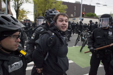 Police detain a demonstrator during an anti-capitalist protest in Seattle, Washington, May 1, 2015. REUTERS/David Ryder