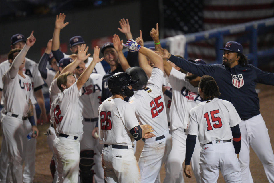 PORT ST. LUCIE, FLORIDA - JUNE 05: Todd Frazier #25 of United States celebrates with teammates after hitting a homerun in the seventh inning against the  during the WBSC Baseball Americas Qualifier Super Round at Clover Park on June 05, 2021 in Port St. Lucie, Florida. (Photo by Mark Brown/Getty Images)