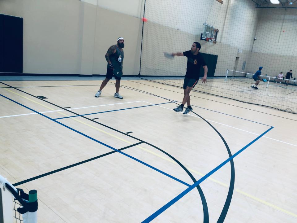 Victor Montes, right, a nurse practitioner, was among the pickleball players who came the the aid of a fellow competitor who suffered a heart attack during a round robin tournament in Palm Desert, Calif., on June 5, 2022.