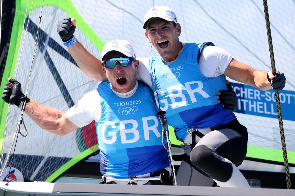 Dylan Fletcher (R) and Stuart Bithell of Team Great Britain celebrate as they win gold in the Men’s Skiff 49er class (Getty Images)