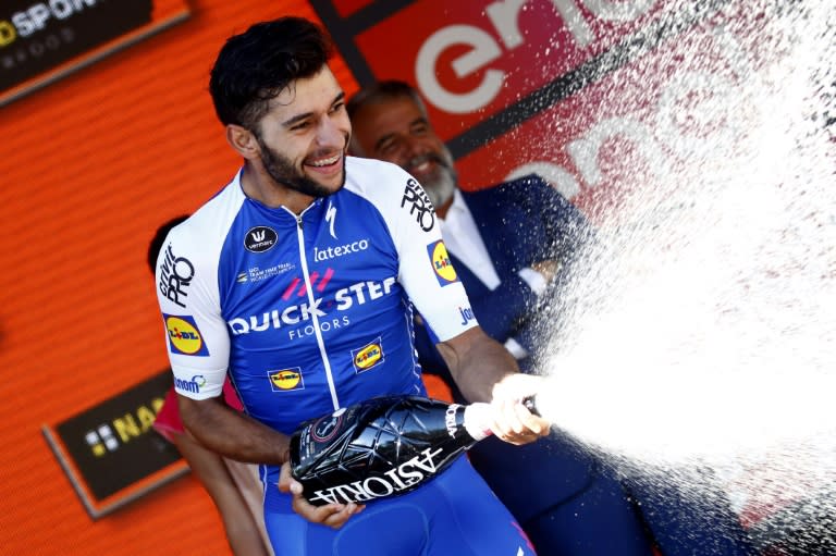 Colombian Fernando Gaviria, of the Quick Step team, celebrates on the podium after winning the 13th stage of the 100th Giro d'Italia, Tour of Italy cycling race, from Reggio Emilia to Tortona on May 19, 2017