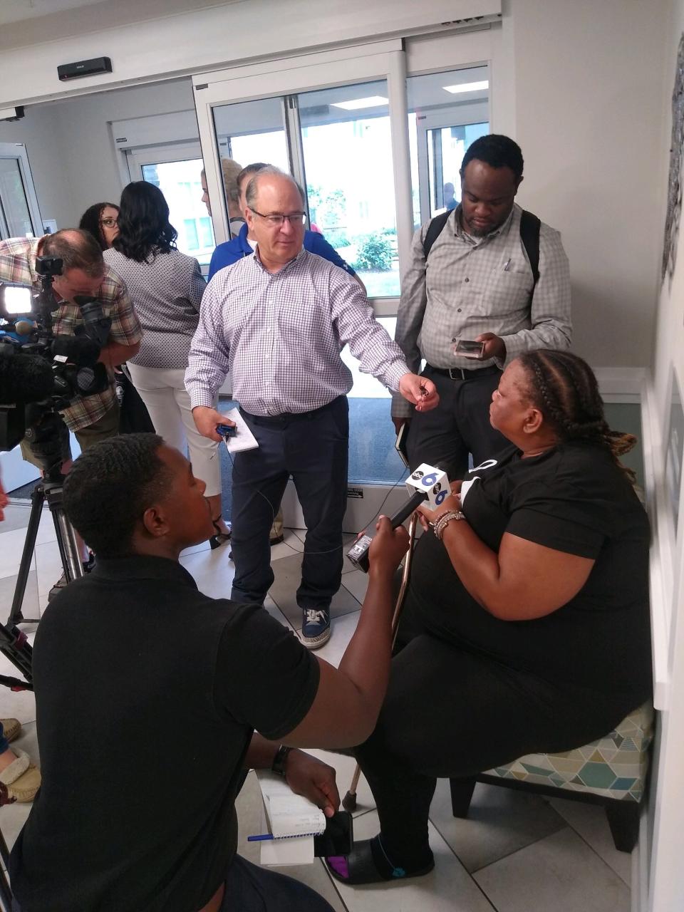 Dorethea Dudley, right, speaks to reporters about crime in her senior living apartment complex parking lot in Northland.