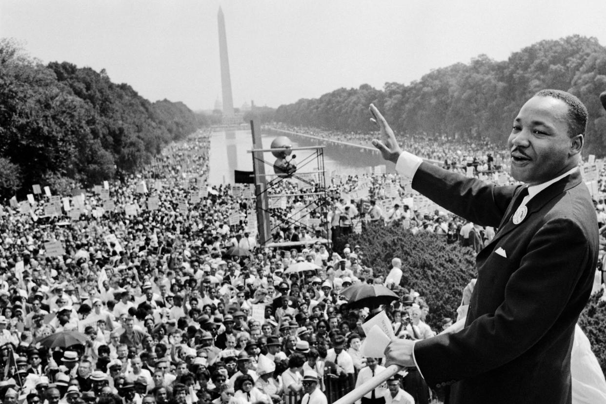 Martin Luther King Jr. waves to supporters on the Mall during the 