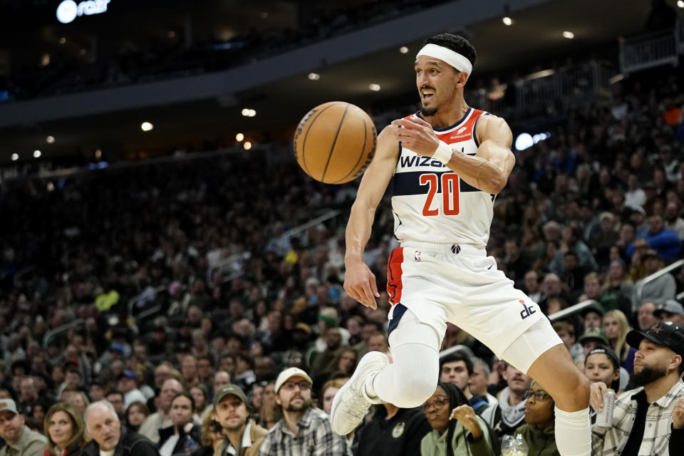 Washington Wizards' Landry Shamet saves the ball from going out of bounds during the first half of the team's NBA basketball In-Season Tournament game against the Milwaukee Bucks on Friday, Nov. 24, 2023, in Milwaukee. (AP Photo/Aaron Gash)