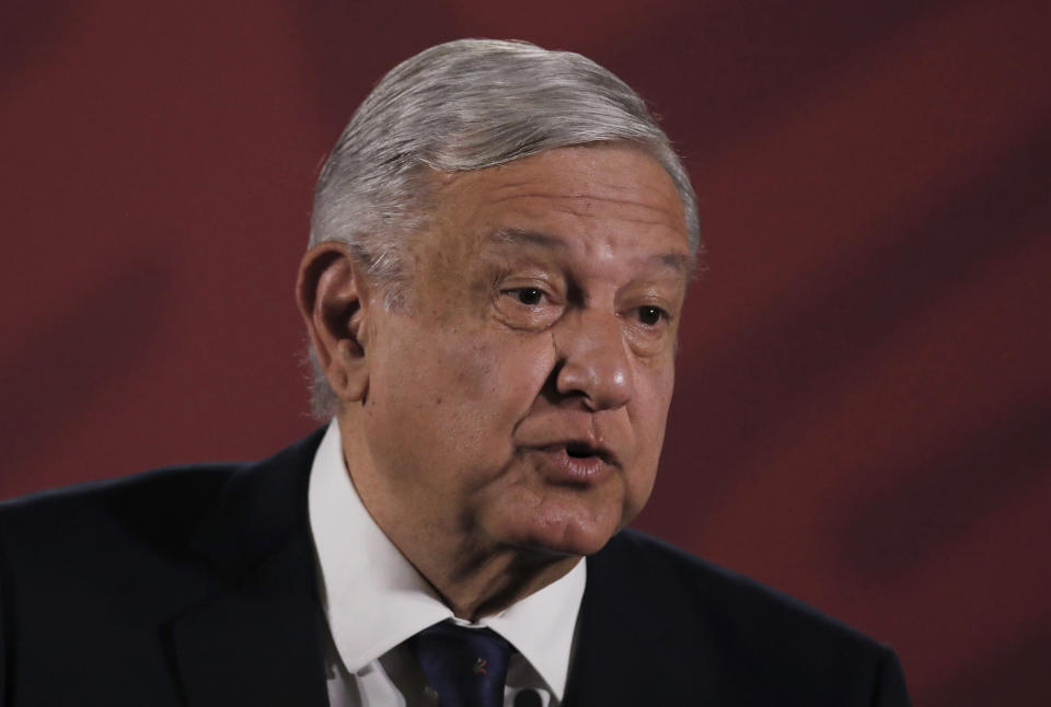 Mexico's President Andres Manuel Lopez Obrador arrives for his daily news conference, with health officials, at the presidential palace in Mexico City, Tuesday, March 24, 2020. Mexican health officials on Tuesday called on all businesses and organizations to suspend work that requires the movement of people, to help stop the spread of the new coronavirus. (AP Photo/Marco Ugarte)