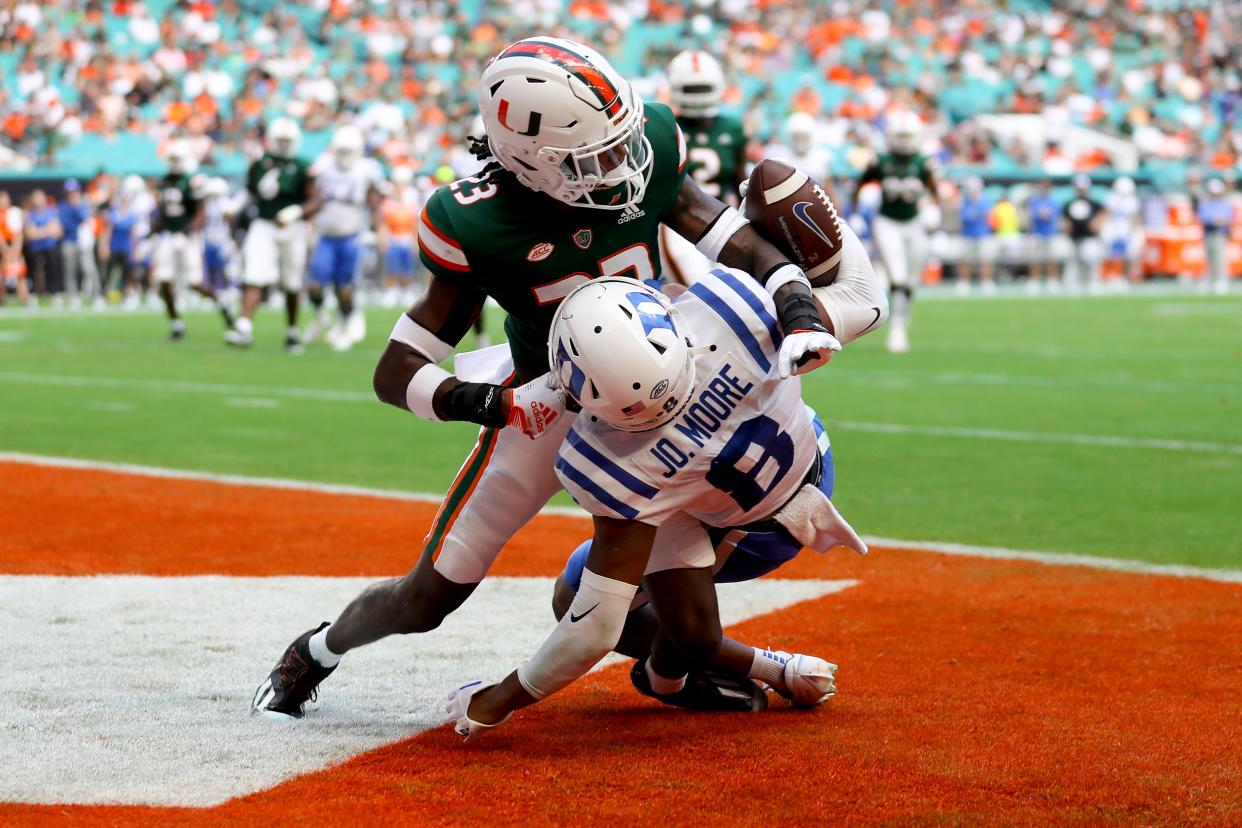 MIAMI GARDENS, FLORIDA - OCTOBER 22: Te'Cory Couch #23 of the Miami Hurricanes breaks up a pass intended for Jordan Moore #8 of the Duke Blue Devils during the second quarter at Hard Rock Stadium on October 22, 2022 in Miami Gardens, Florida. (Photo by Megan Briggs/Getty Images)