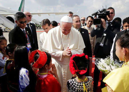 Pope Francis is welcomed as he arrives at Yangon International Airport, Myanmar November 27, 2017. REUTERS/Max Rossi