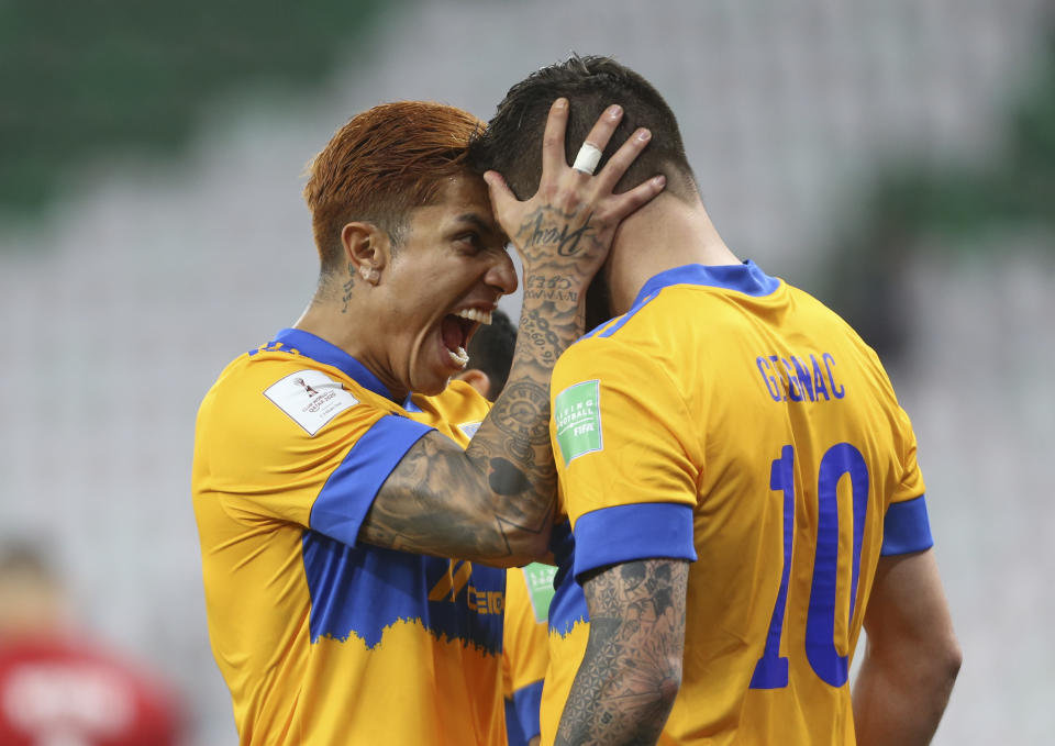 Andre Pierre Cignac of Tigres UANL, right and Carlos Salcedo celebrate during FIFA Club World Cup semi final against Brazil's Palmeiras in Al Rayyan, Qatar, Sunday. Feb. 7, 2021. (AP Photo/Hussein Sayed)