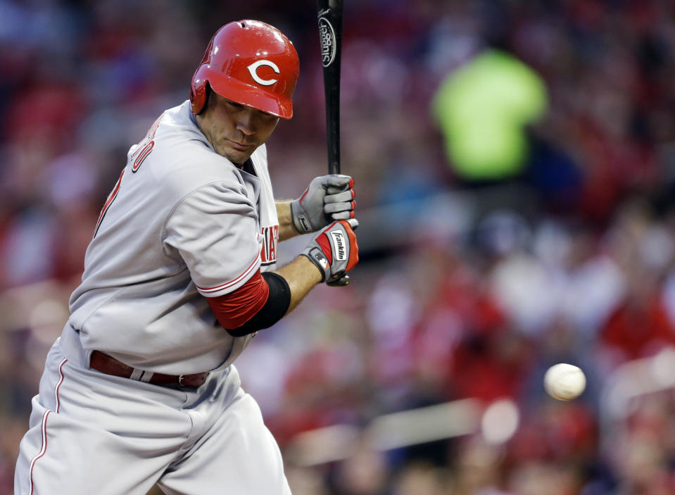 Cincinnati Reds' Joey Votto is hit by a pitch during the first inning of a baseball game against the St. Louis Cardinals on Tuesday, April 8, 2014, in St. Louis. (AP Photo/Jeff Roberson)