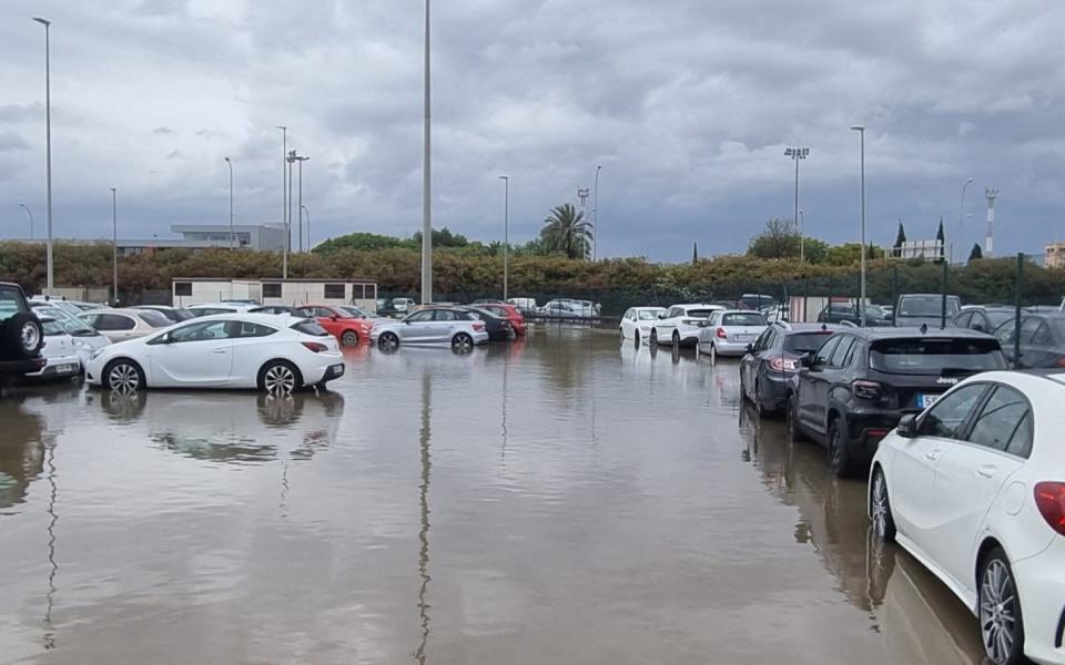 Cars parked in a flooded car park at Palma de Mallorca airport after heavy rains