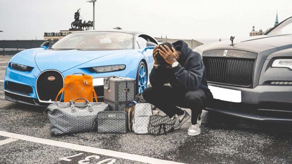 Dennis Schroder (pictured) posing for a photo in front of his cars.