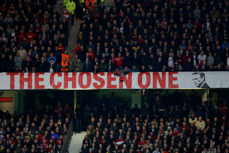 A banner referring to manager David Moyes is seen during their Champions League last 16 second leg soccer match against Olympiakos at Old Trafford Stadium, Manchester, England, Wednesday, March 19, 2014. (AP Photo/Jon Super)