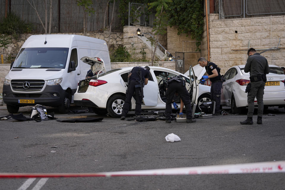 Israeli police investigate the scene of a suspected ramming attack that wounded three people on the eve of the Jewish holiday of Passover, in Jerusalem, Monday, April 22, 2024. Israeli police say a car slammed into pedestrians in Jerusalem on Monday, wounding three people lightly in an apparent attack. (AP Photo/Ohad Zwigenberg)