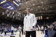 FILE - Duke associate head coach Jon Scheyer walks on the court before the team's NCAA college basketball game against North Carolina in Durham, N.C., March 5, 2022. Scheyer has taken over a program led by a Hall of Fame coach who to many was the face of college basketball in Mike Krzyzewski. And there's a nearly complete roster overhaul with 11 new players after the latest wave of early NBA departures from last year's Final Four team, including No. 1 overall pick Paolo Banchero. (AP Photo/Gerry Broome, File)
