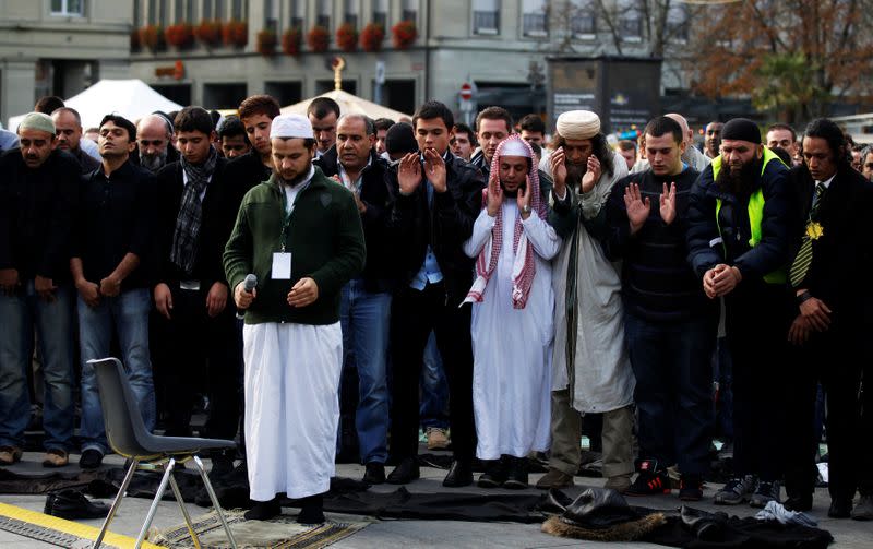 FILE PHOTO: Muslim men pray in front of the Swiss Federal Palace during a protest against islamophobia and racism in Bern