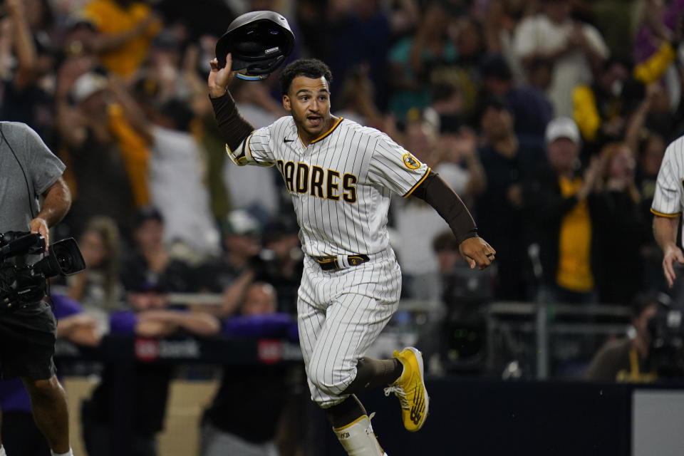 San Diego Padres' Trent Grisham celebrates after hitting a walk-off home run during the ninth inning of the second baseball game of a doubleheader against the Colorado Rockies, Tuesday, Aug. 2, 2022, in San Diego. (AP Photo/Gregory Bull)