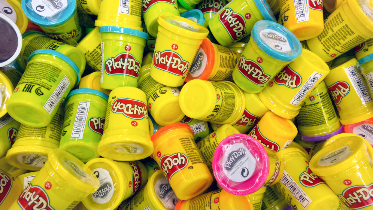 Paphos, Cyprus - October 18, 2016 Heap of Play-Doh containers with difrent color modeling compound.