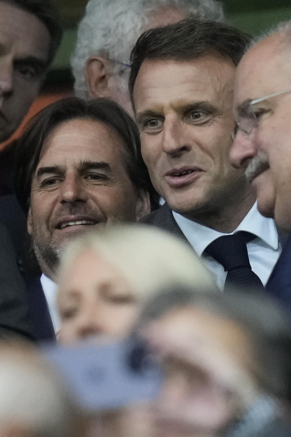 French President Emmanuel Macron, centre, and Uruguay's President Luis Lacalle Pou, left, wait for the start of the Rugby World Cup Pool A match between France and Uruguay at the Pierre Mauroy stadium in Villeneuve-d'Ascq, near Lille, France, Thursday, Sept. 14, 2023. (AP Photo/Thibault Camus)