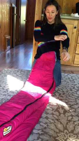 <p>Jennifer Garner/Instagram</p> Garner rolled up her sleeves as she prepared to try and get the sleeping bag back into its sack