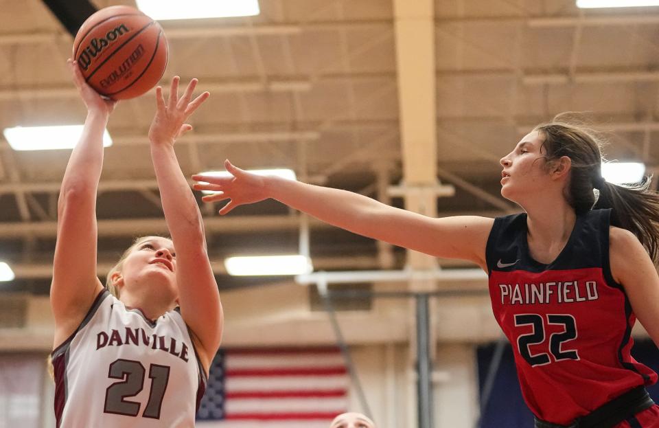 Danville's forward Addison Davis (21) attempts to score against Plainfield Quakers guard Hannah Menser (22) on Saturday, Jan. 6, 2024, during the game at Danville Community High School in Danville.